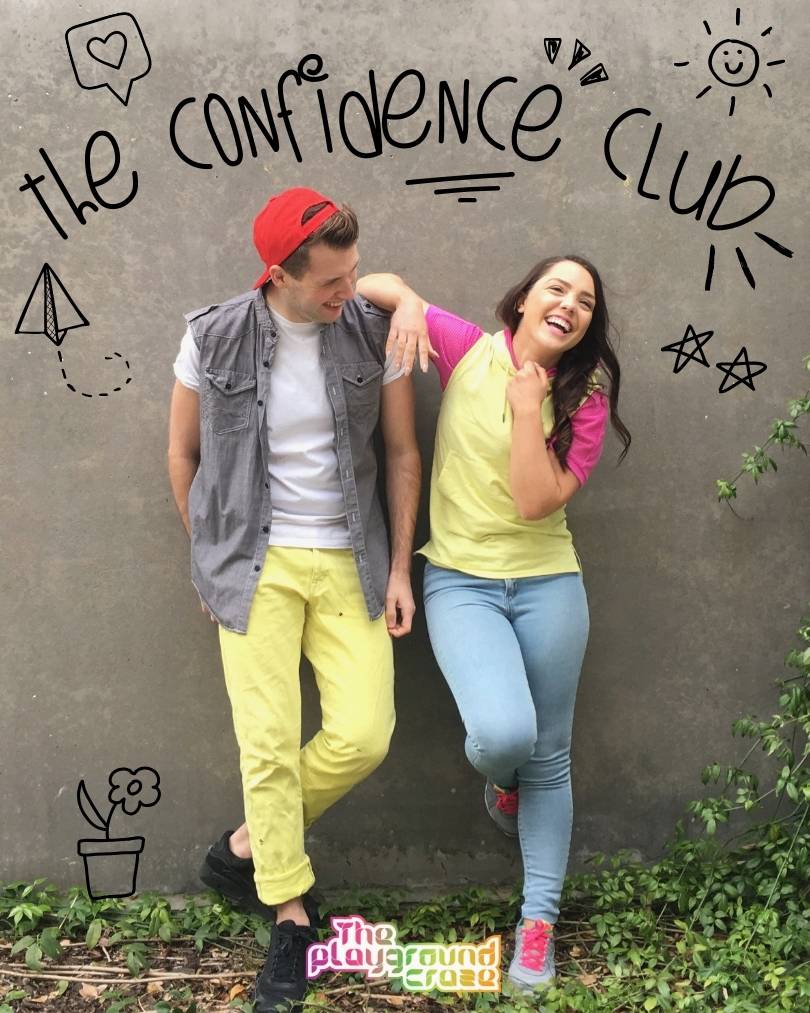 The Confidence Club, boy and girl leaning against wall laughing